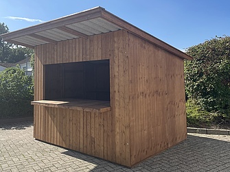Der Verkaufsstand auf einem gepflasterten Hof, schräg von der anderen Seite